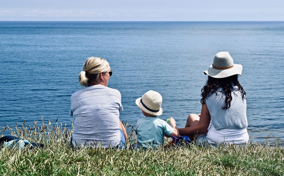 family sat on bank looking out to see