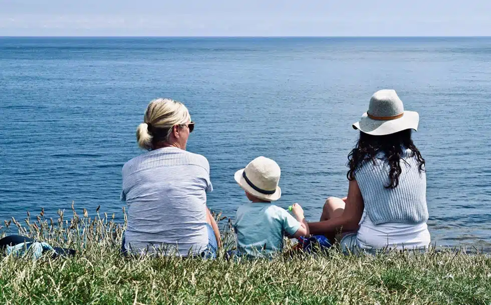 family sat on bank looking out to see